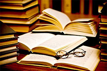 A table with some books and glasses on it